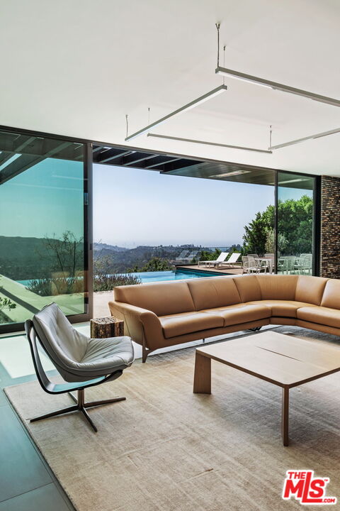 2200 Stradella Road Los Angeles, CA 90077 - Photo 8 of 27 a living room with furniture and a floor to ceiling window