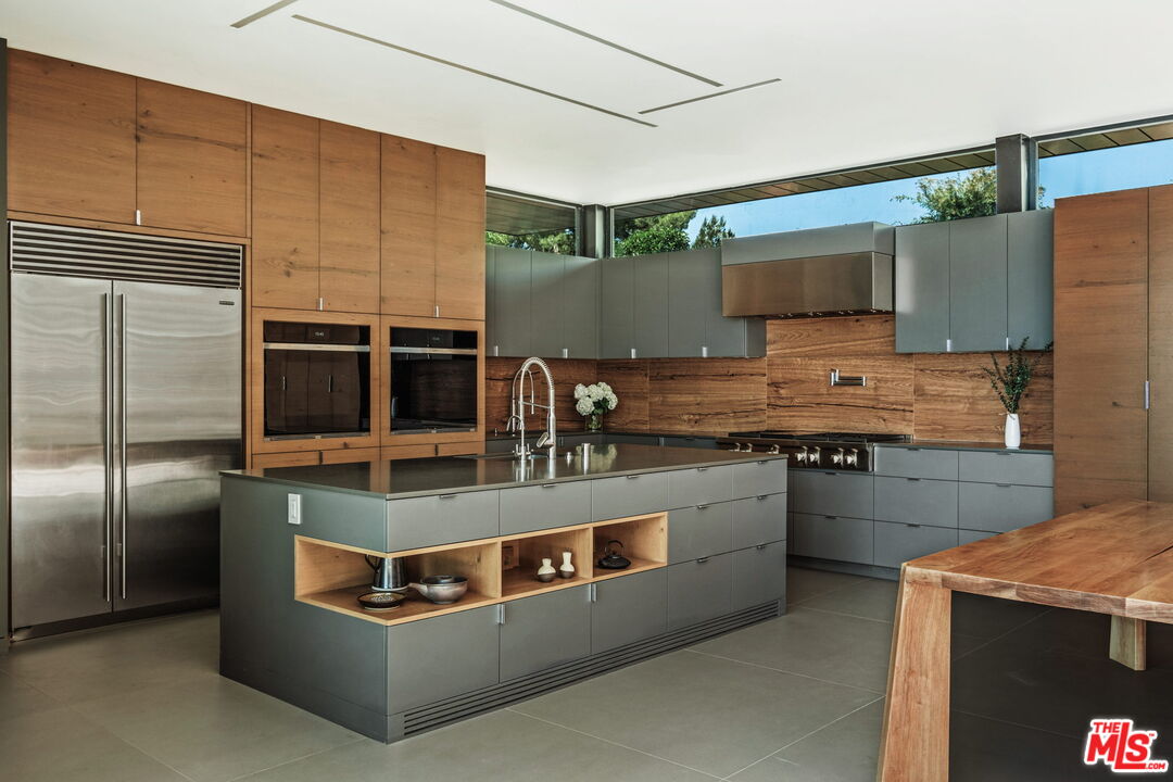 2200 Stradella Road Los Angeles, CA 90077 - Photo 9 of 27 a kitchen with stainless steel appliances granite countertop a stove a sink and a refrigerator