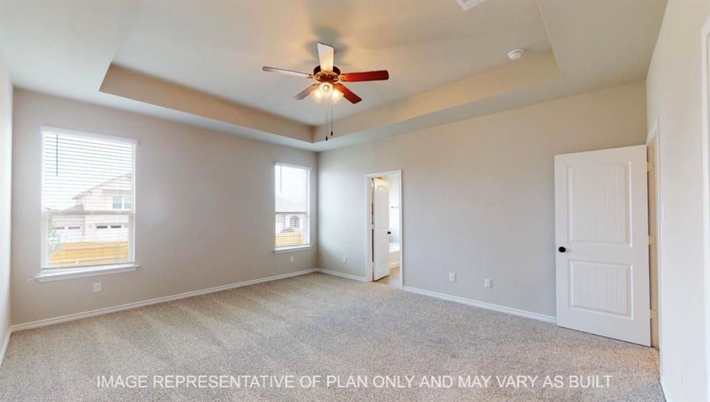 10720 Granada Drive Waco, TX 76708 - Photo 10 of 25 Unfurnished bedroom with a raised ceiling, light colored carpet, connected bathroom, and ceiling fan