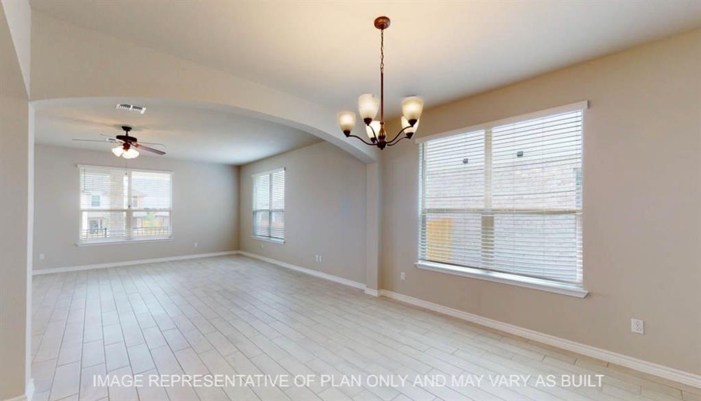 10720 Granada Drive Waco, TX 76708 - Photo 6 of 25 Empty room with a ceiling fan, arched walkways, a chandelier, and light wood-style flooring