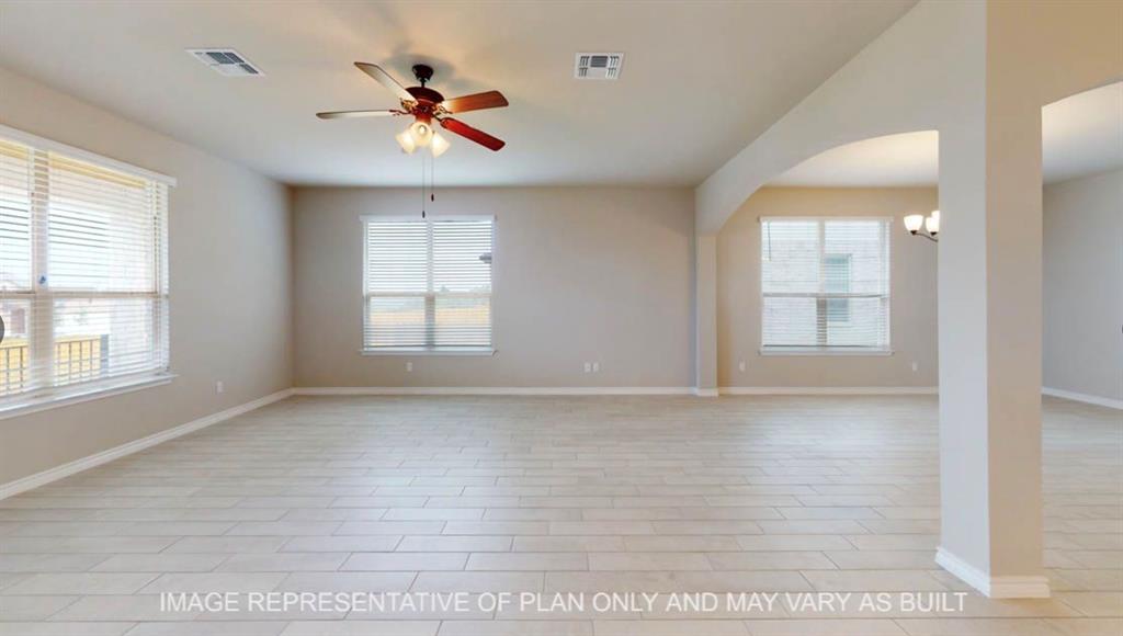 10720 Granada Drive Waco, TX 76708 - Photo 7 of 25 Empty room featuring a ceiling fan and a chandelier