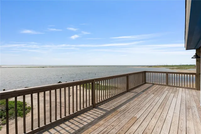 a view of an empty room and wooden floor