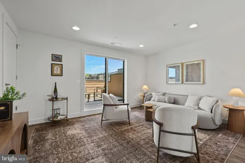 a living room with furniture and a chair