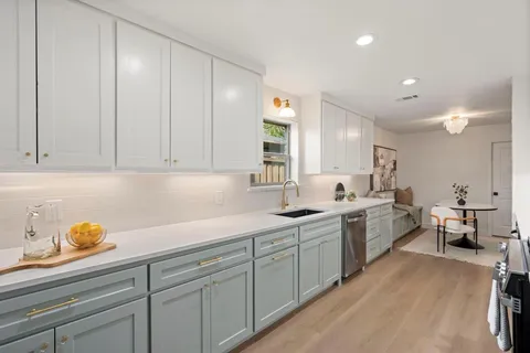 a kitchen with sink and cabinets