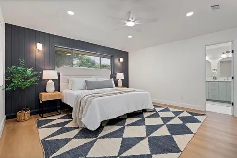 a bedroom with a bed and a mirror