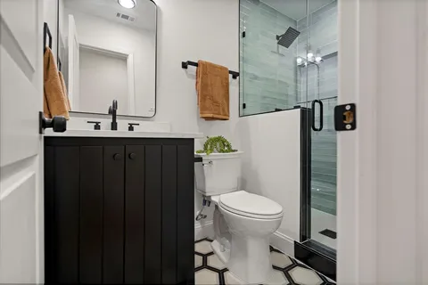 a bathroom with a sink toilet and mirror