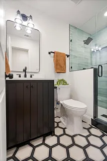a bathroom with a toilet a sink and mirror