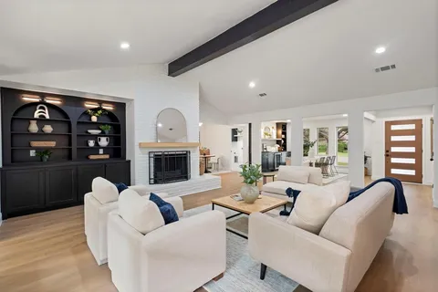 a living room with furniture fireplace and a flat screen tv