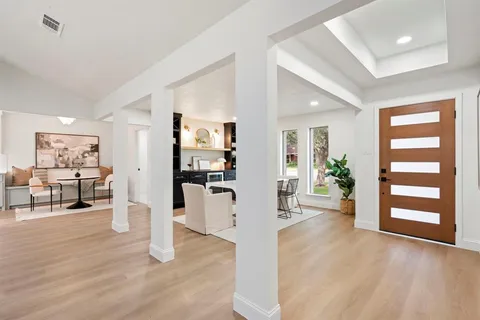 a view of a living room kitchen and a window