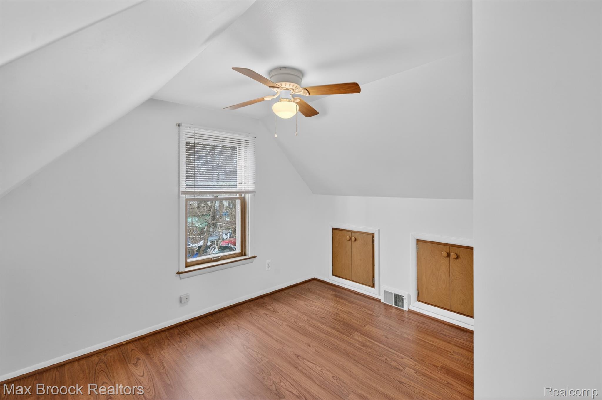 9024 Mandon Road White Lake, MI 48386 - Photo 24 of 39 Additional living space featuring a ceiling fan and wood finished floors