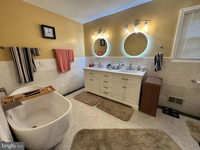 a bedroom with a bed and a mirror