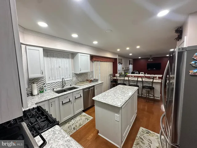 a kitchen with a sink stove and refrigerator