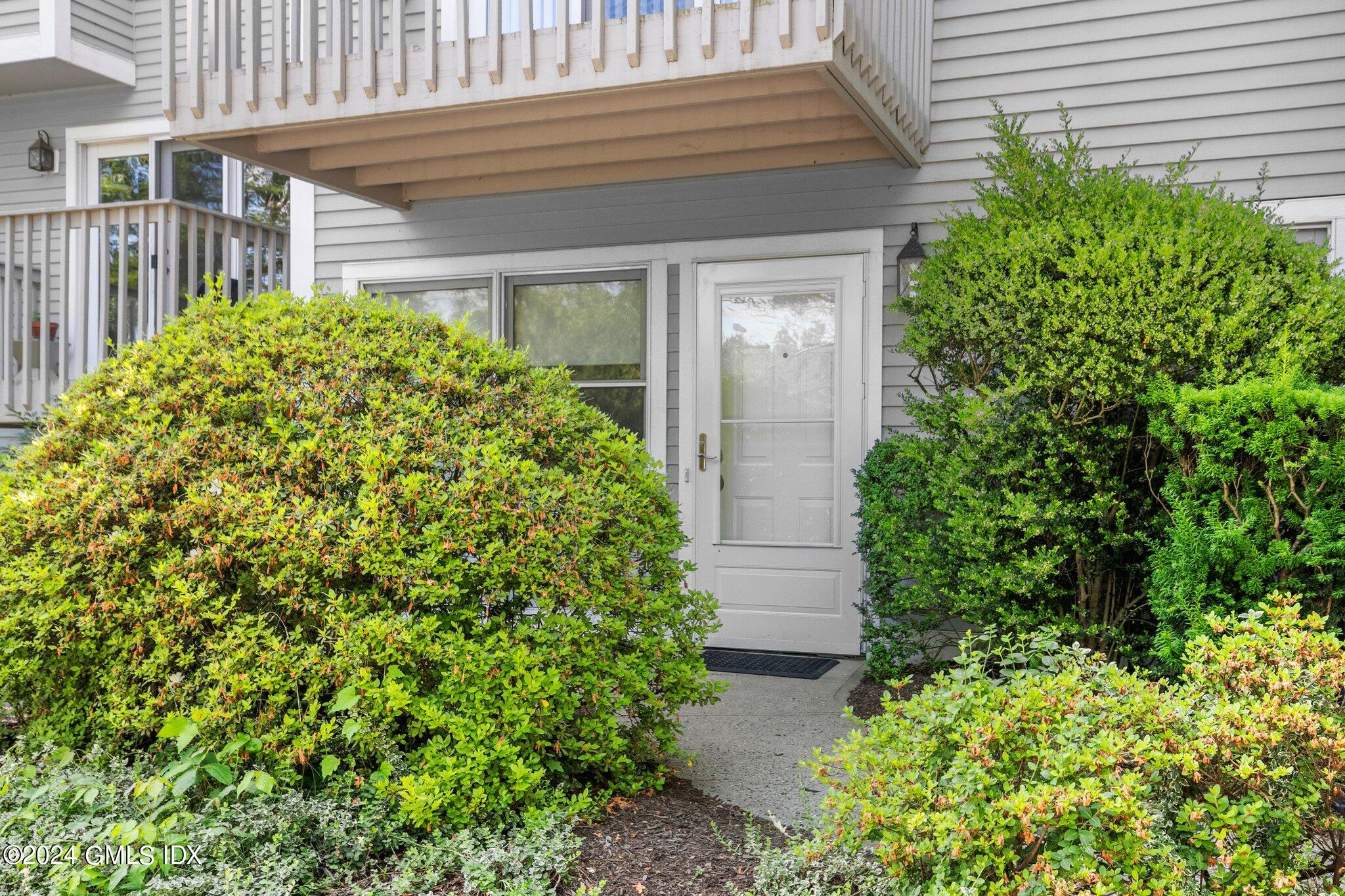 351 Pemberwick Road, Unit 109 Greenwich, CT 06831 - Photo 2 of 9 a view of a backyard with potted plants