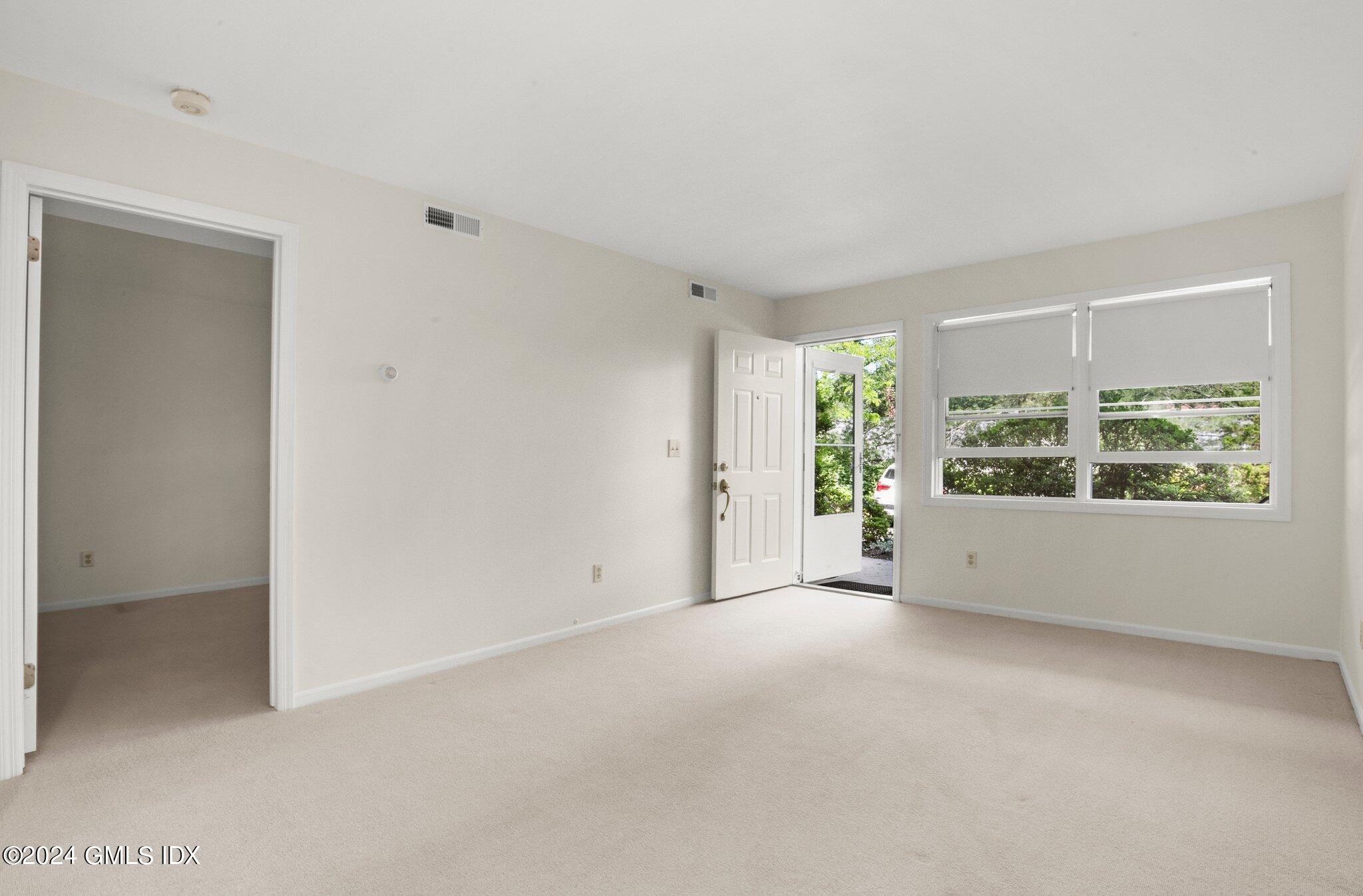 351 Pemberwick Road, Unit 109 Greenwich, CT 06831 - Photo 4 of 9 a view of an empty room with a window