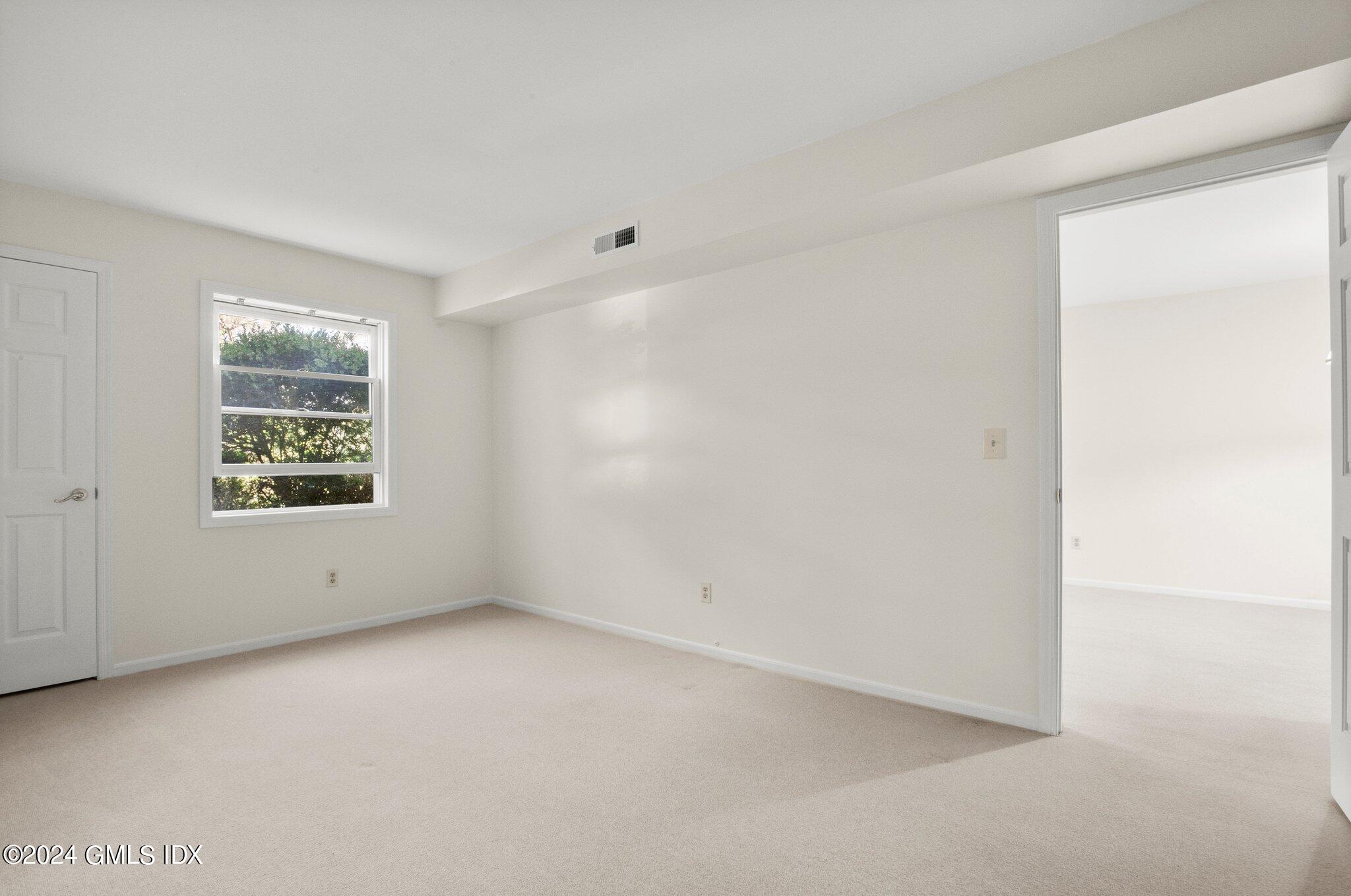 351 Pemberwick Road, Unit 109 Greenwich, CT 06831 - Photo 7 of 9 an empty room with windows