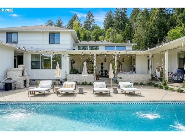 a view of house with backyard and outdoor seating