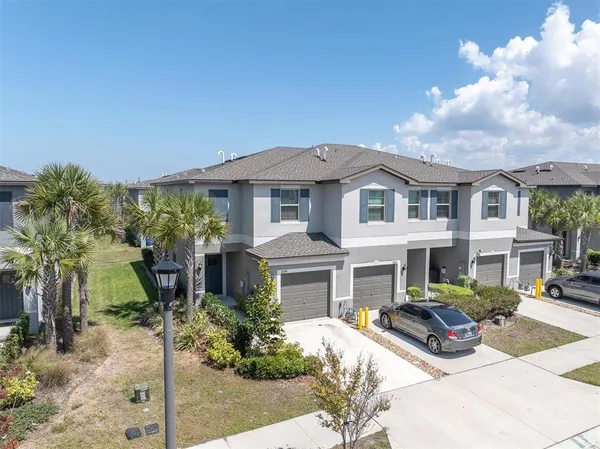 a front view of a house with garden and plants