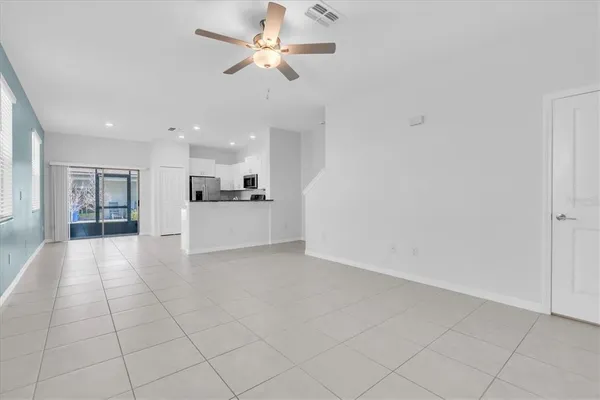 a view of a kitchen with a sink and a chandelier fan