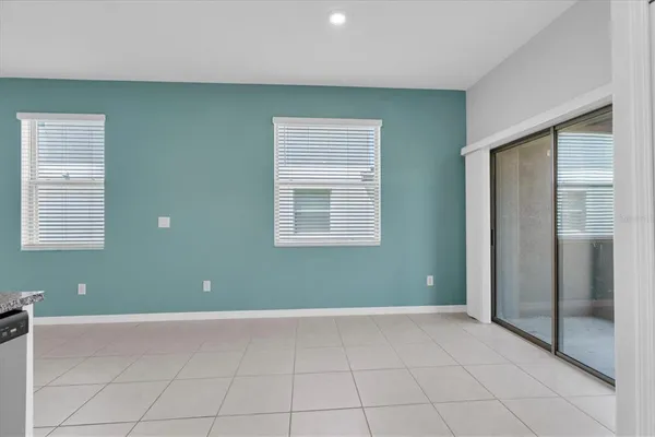 an empty room with closet and windows