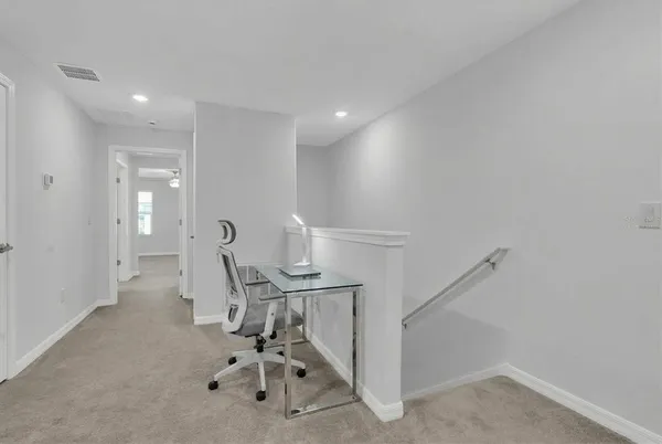 a view of a hallway with seating area