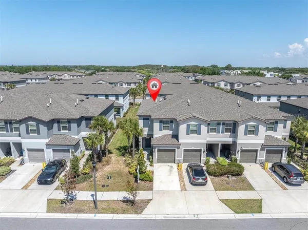 an aerial view of residential houses with outdoor space