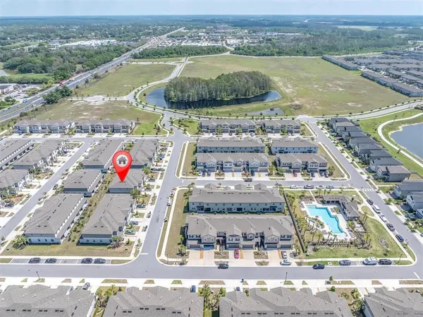 an aerial view of residential houses with outdoor space