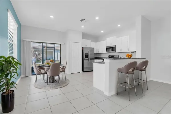 a dining room filled counter top space and stainless steel appliances