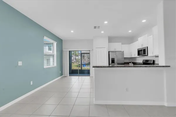 a kitchen with stainless steel appliances a refrigerator sink and microwave