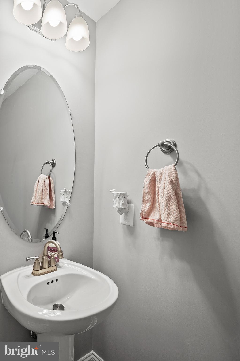 898 Marigold Road Glen Burnie, MD 21060 - Photo 13 of 33 a bathroom with a sink and mirror