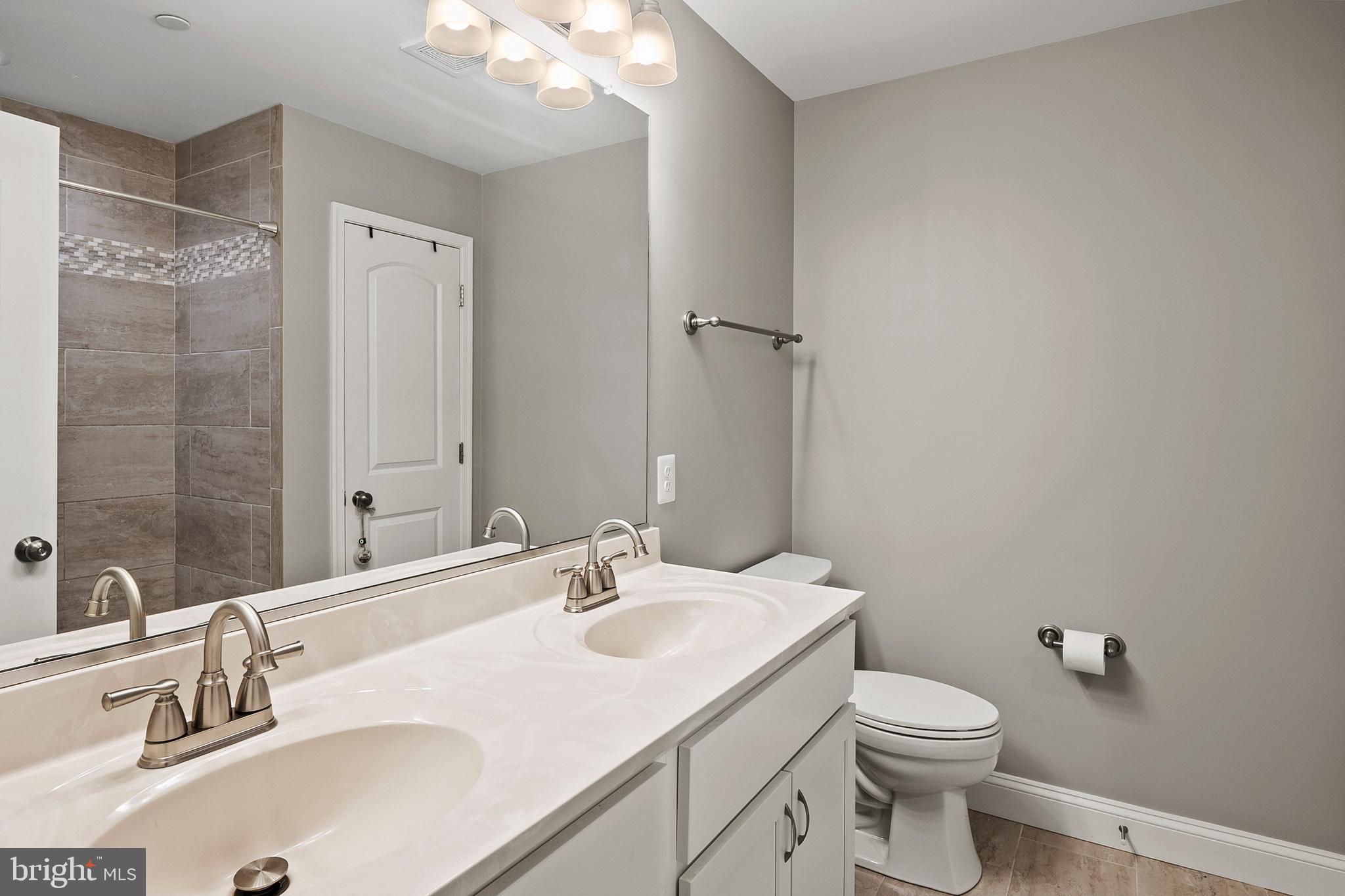 898 Marigold Road Glen Burnie, MD 21060 - Photo 18 of 33 a bathroom with a sink toilet and shower