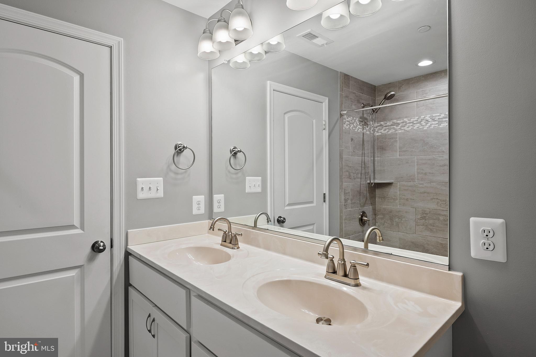 898 Marigold Road Glen Burnie, MD 21060 - Photo 19 of 33 a bathroom with a sink double vanity and a mirror