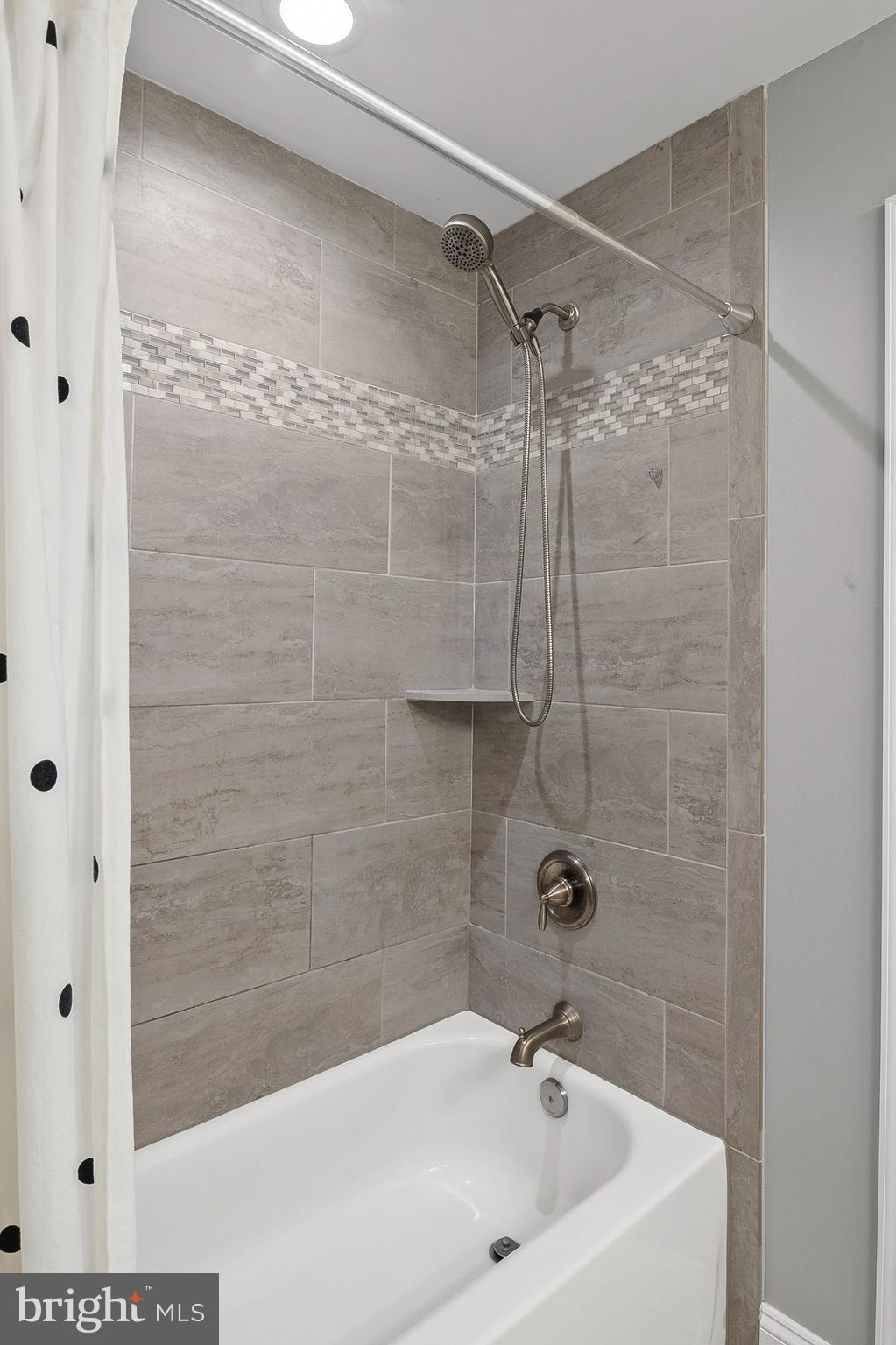 898 Marigold Road Glen Burnie, MD 21060 - Photo 20 of 33 a bathroom with a white bath tub and a shower