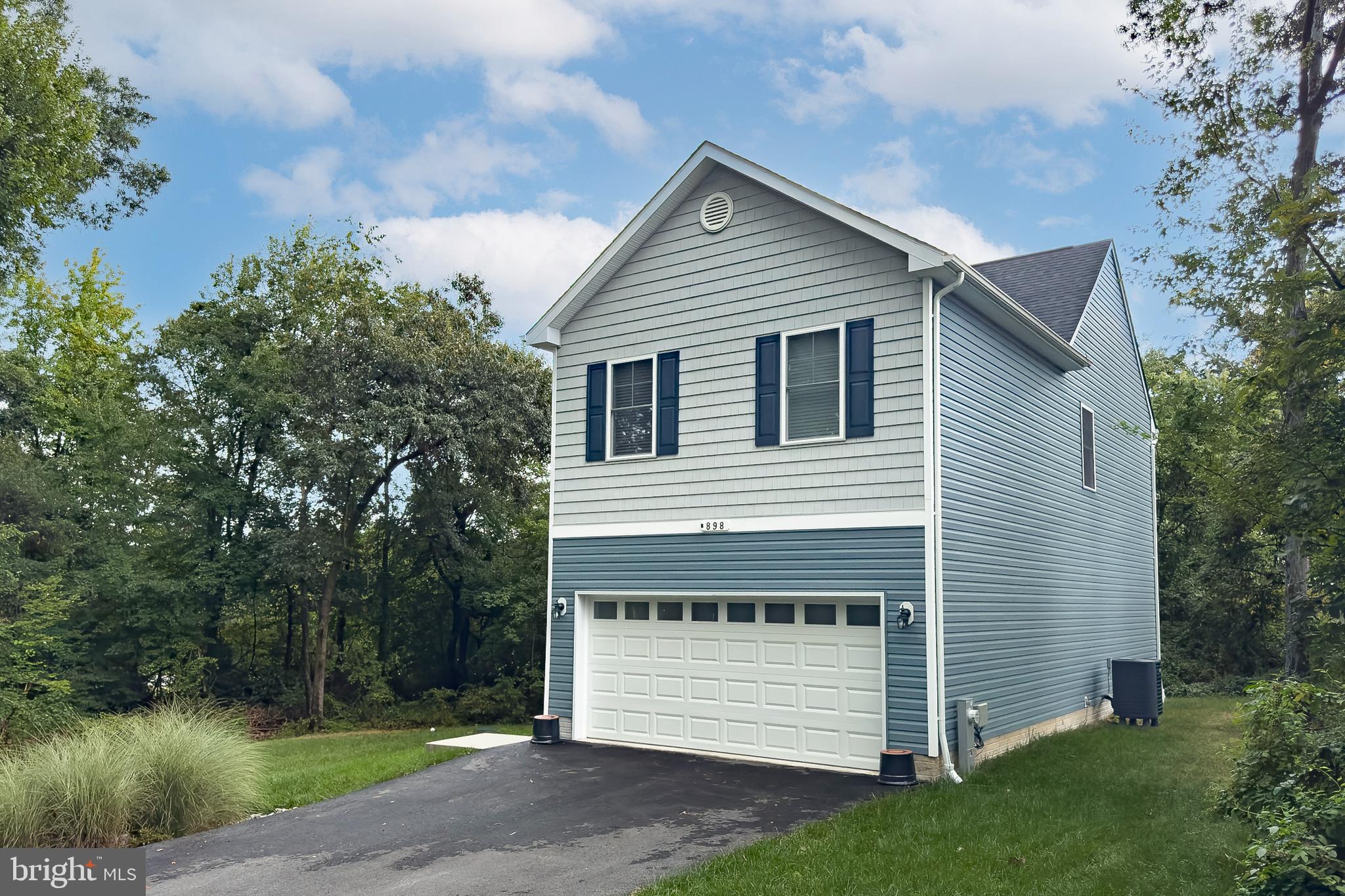 898 Marigold Road Glen Burnie, MD 21060 - Photo 3 of 33 a front view of a house with a yard and garage