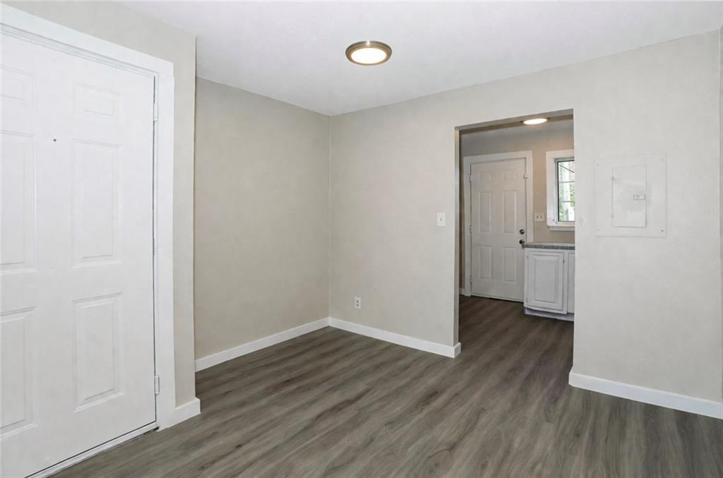 2055 Alison Court Southwest, Unit 8 Atlanta, GA 30311 - Photo 2 of 12 an empty room with wooden floor and windows