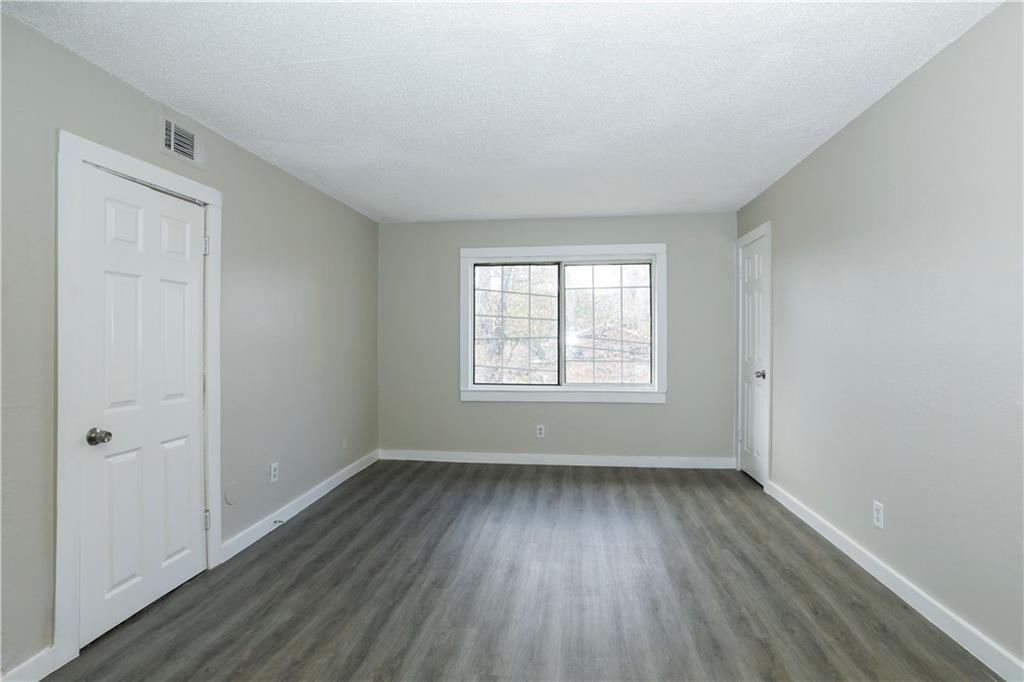 2055 Alison Court Southwest, Unit 8 Atlanta, GA 30311 - Photo 4 of 12 an empty room with wooden floor and windows