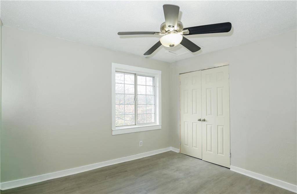 2055 Alison Court Southwest, Unit 8 Atlanta, GA 30311 - Photo 5 of 12 an empty room with a window and a fan