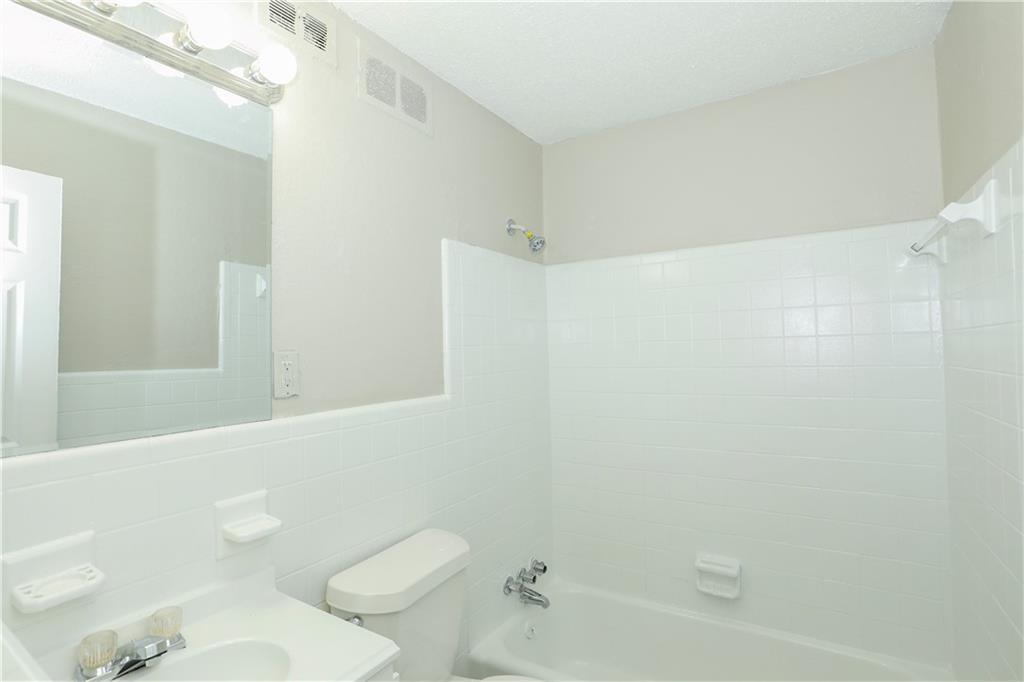 2055 Alison Court Southwest, Unit 8 Atlanta, GA 30311 - Photo 10 of 12 a bathroom with a sink a toilet and shower