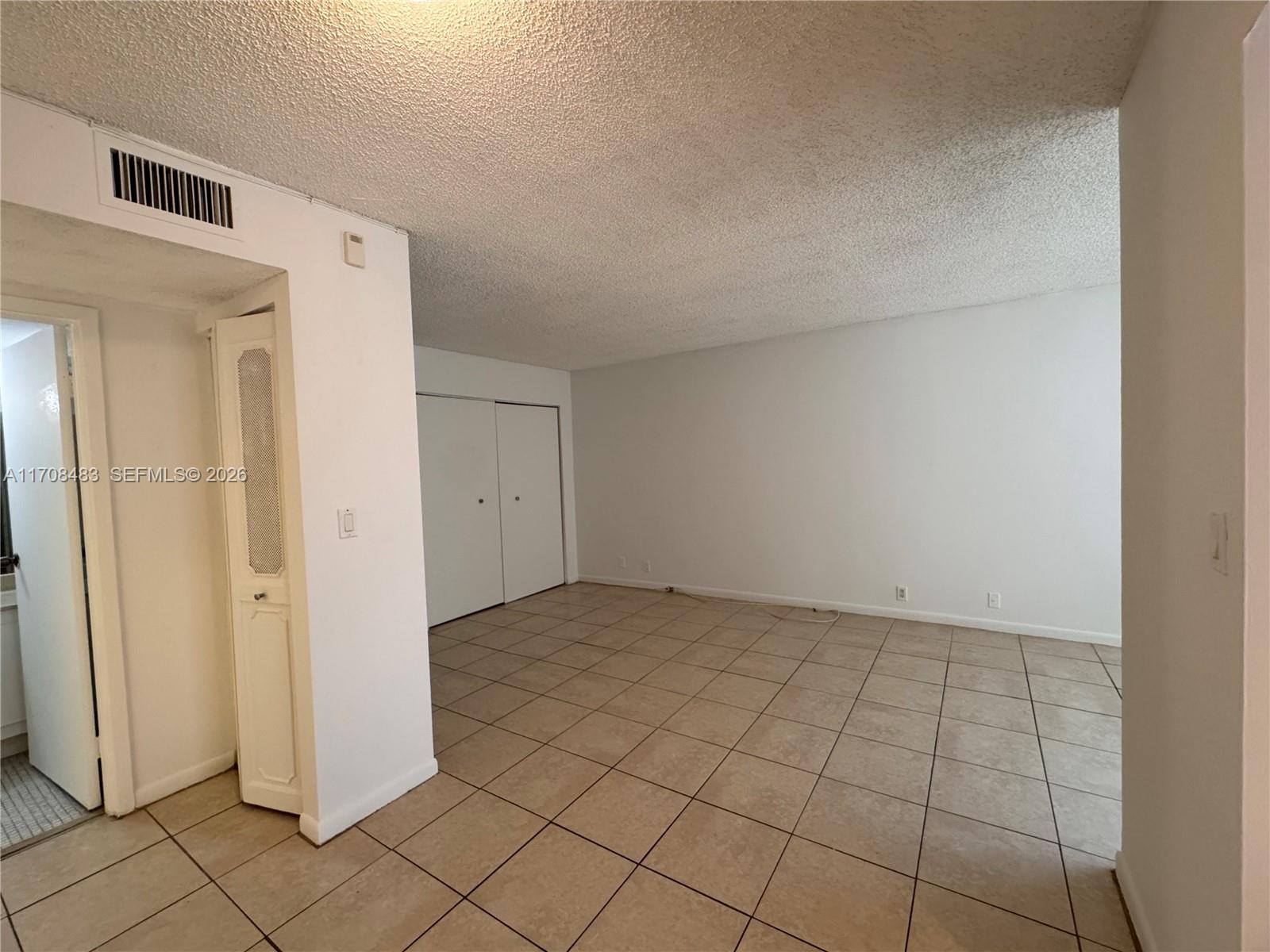 16919 North Bay Road, Unit 117 Sunny Isles Beach, FL 33160 - Photo 11 of 20 an empty room with windows