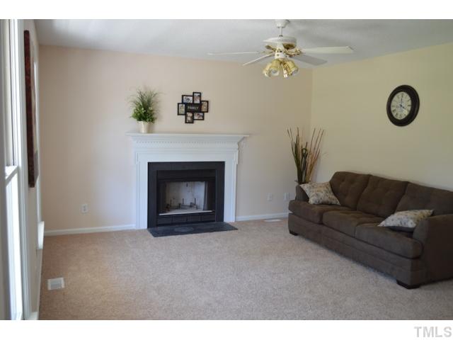 232 Pope Lake Road Angier, NC 27501 - Photo 3 of 15 a living room with furniture a chandelier and a fireplace