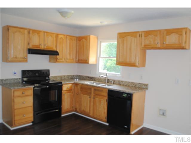 232 Pope Lake Road Angier, NC 27501 - Photo 6 of 15 a kitchen with a sink stove top oven and cabinets