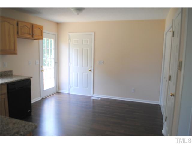 232 Pope Lake Road Angier, NC 27501 - Photo 7 of 15 a view of an empty room with wooden floor and a window