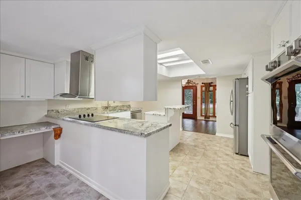 a kitchen with a sink stove and cabinets