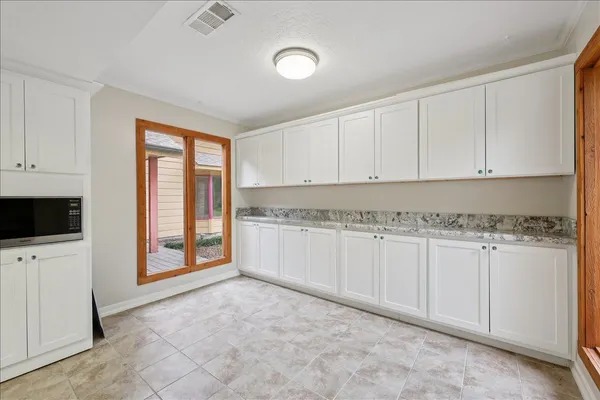 a view of a kitchen with electric appliances