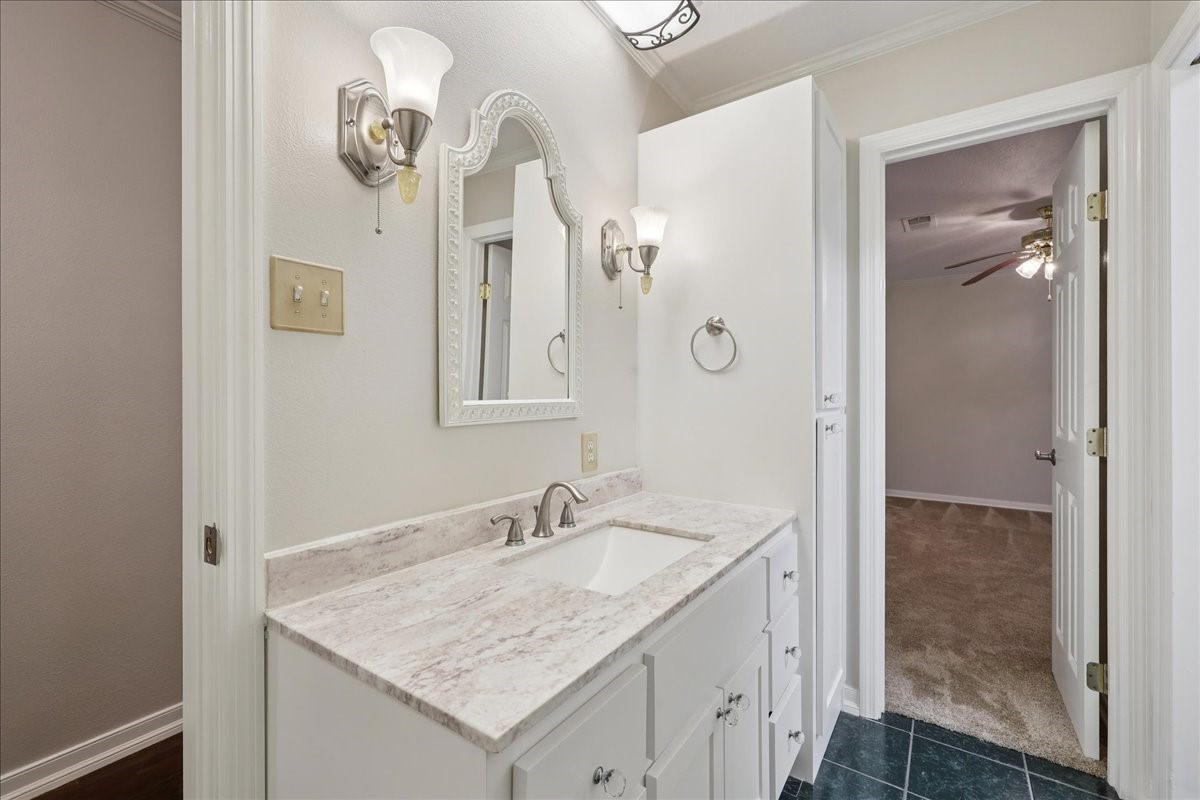3805 Huntwick Street Orange, TX 77632 - Photo 18 of 43 a bathroom with a granite countertop sink a mirror and a shower