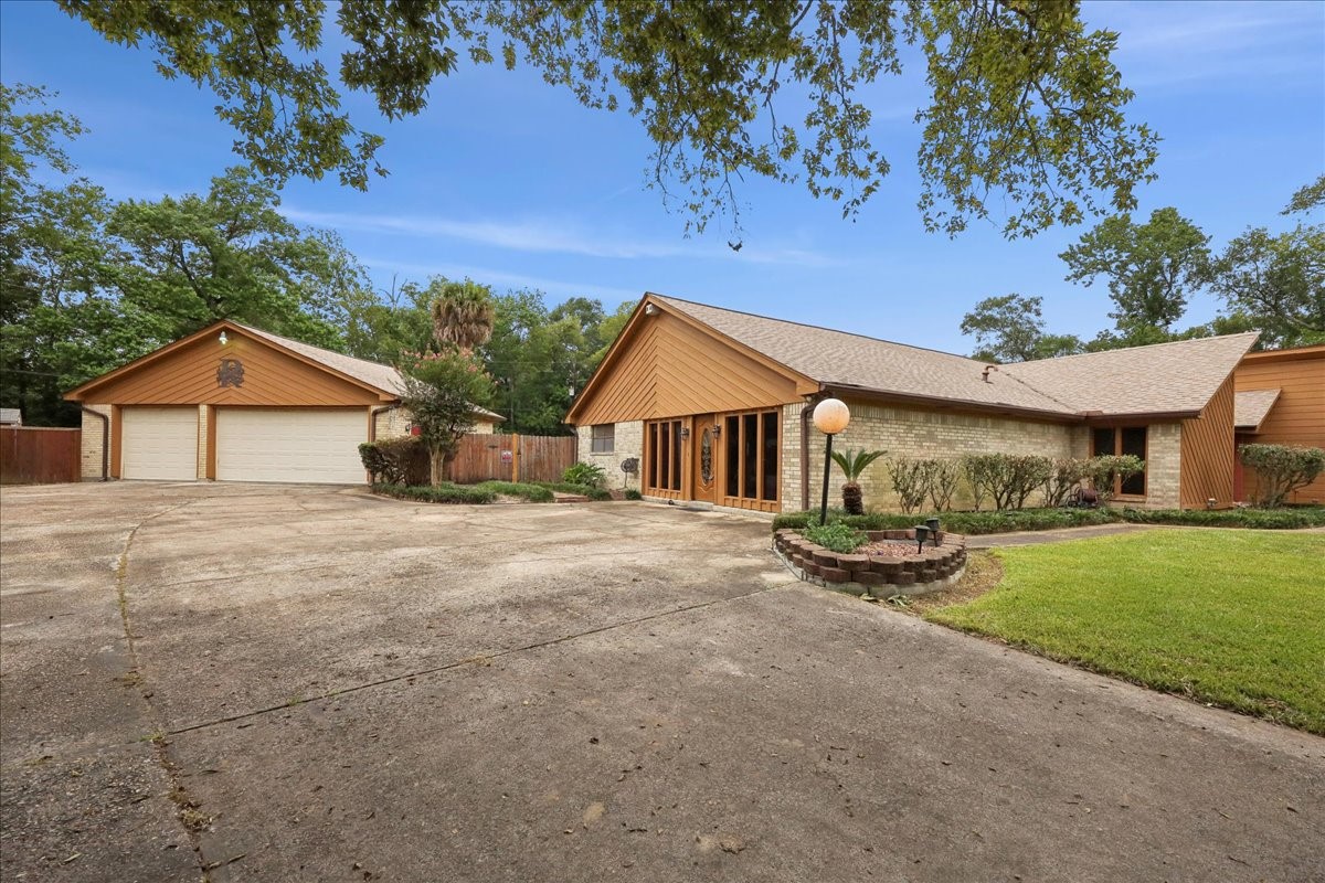 3805 Huntwick Street Orange, TX 77632 - Photo 2 of 43 a view of a house with backyard and garden