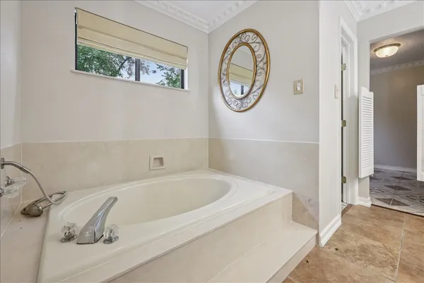 a bathroom with a bathtub and a window