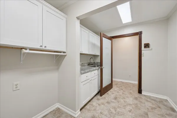 a kitchen with white cabinets and white appliances