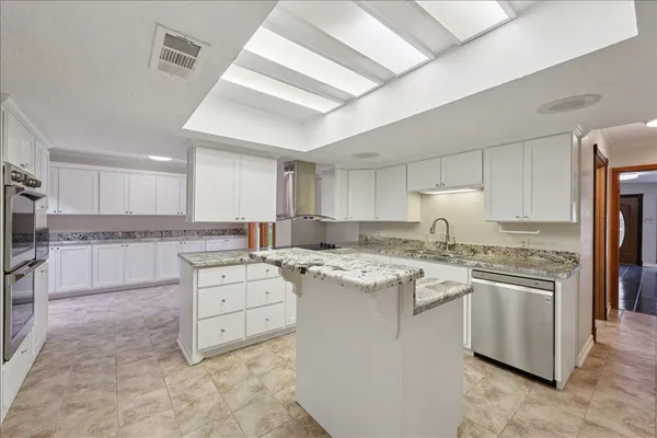 a kitchen with a stove a sink and a refrigerator