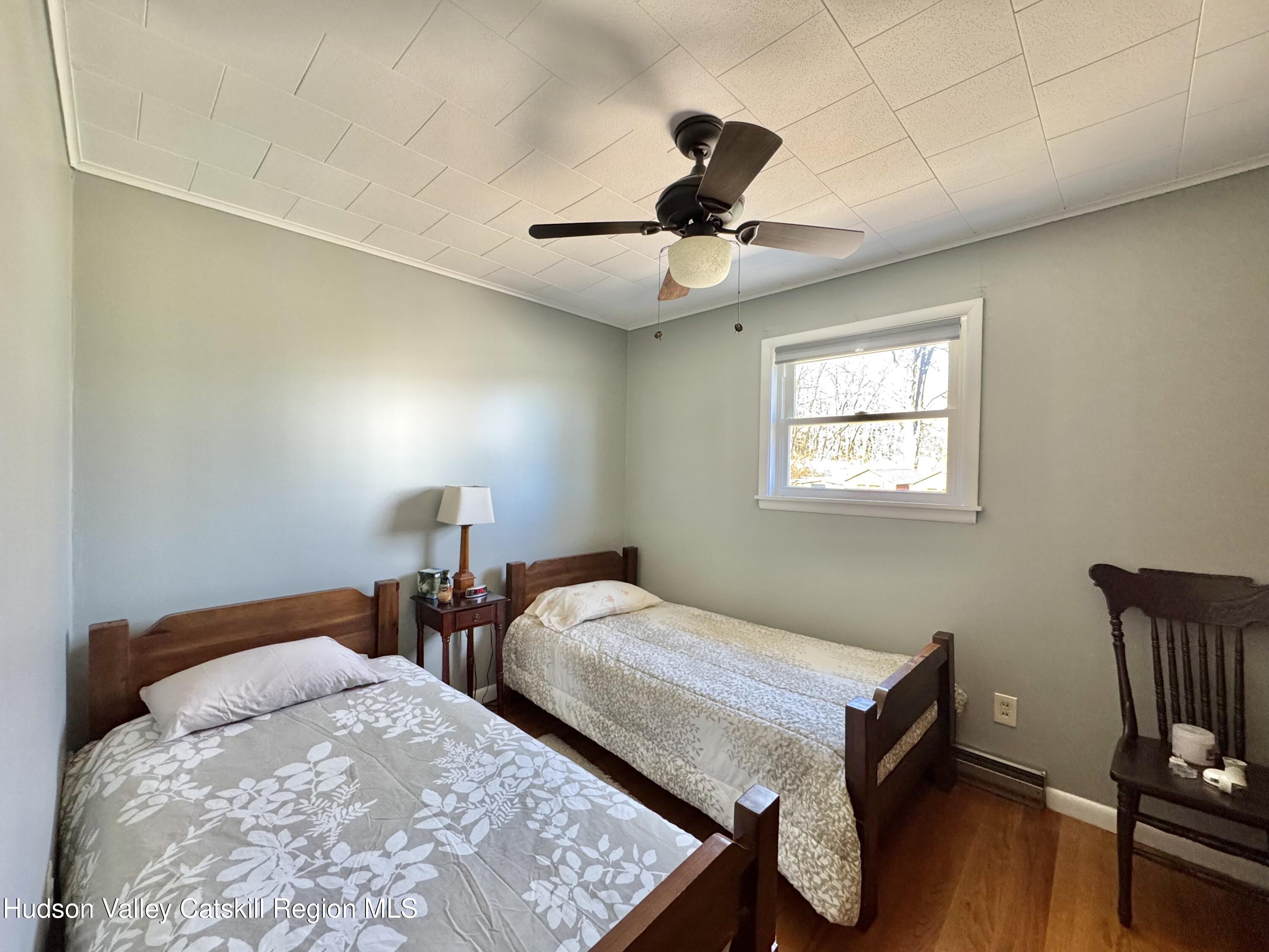 6339-6347 Highway 32 Catskill, NY 12413 - Photo 11 of 35 a bedroom with two beds and a desk