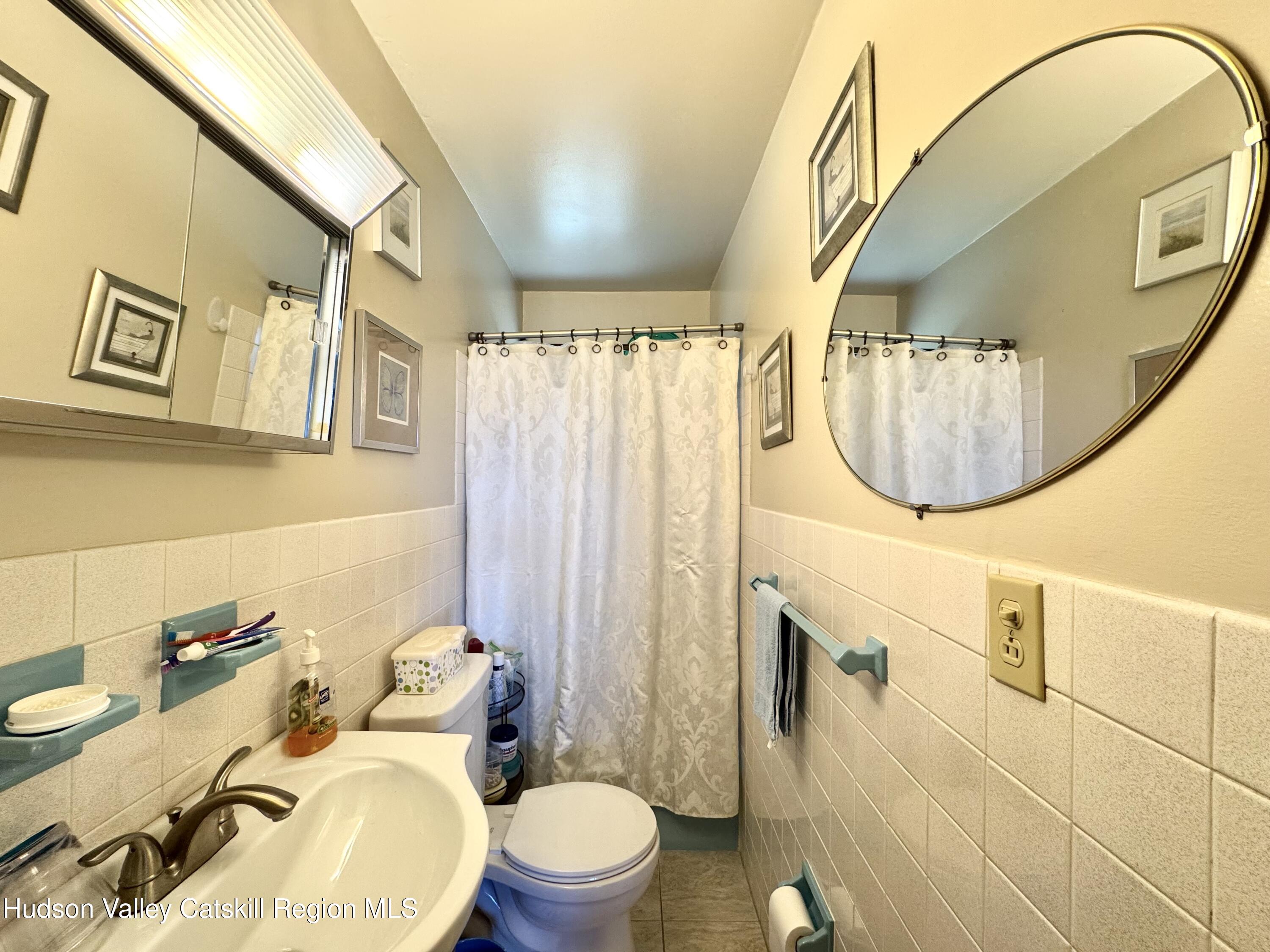 6339-6347 Highway 32 Catskill, NY 12413 - Photo 13 of 35 a bathroom with a toilet sink and mirror
